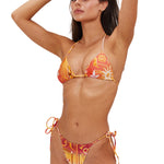 Woman wearing a colorful bikini set on a white background