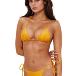 Woman wearing a yellow bikini on a white background