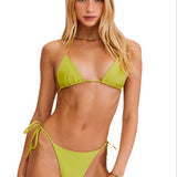 Woman wearing a green bikini set on a white background