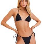 Woman wearing a black bikini set on a white background