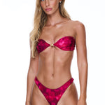 Woman wearing a red bikini against a white background