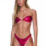 Woman wearing a red bikini against a white background