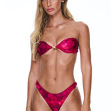 Woman wearing a red bikini against a white background