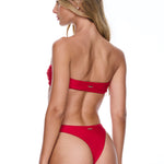 Woman wearing a red bikini on a white background