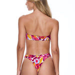 Woman wearing a colorful floral bikini on a white background