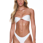 Woman wearing a white bikini on a white background