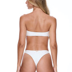 Woman wearing a white bikini on a white background