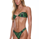 Woman wearing a green and black patterned bikini on a white background