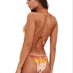 Woman wearing a colorful bikini on a white background